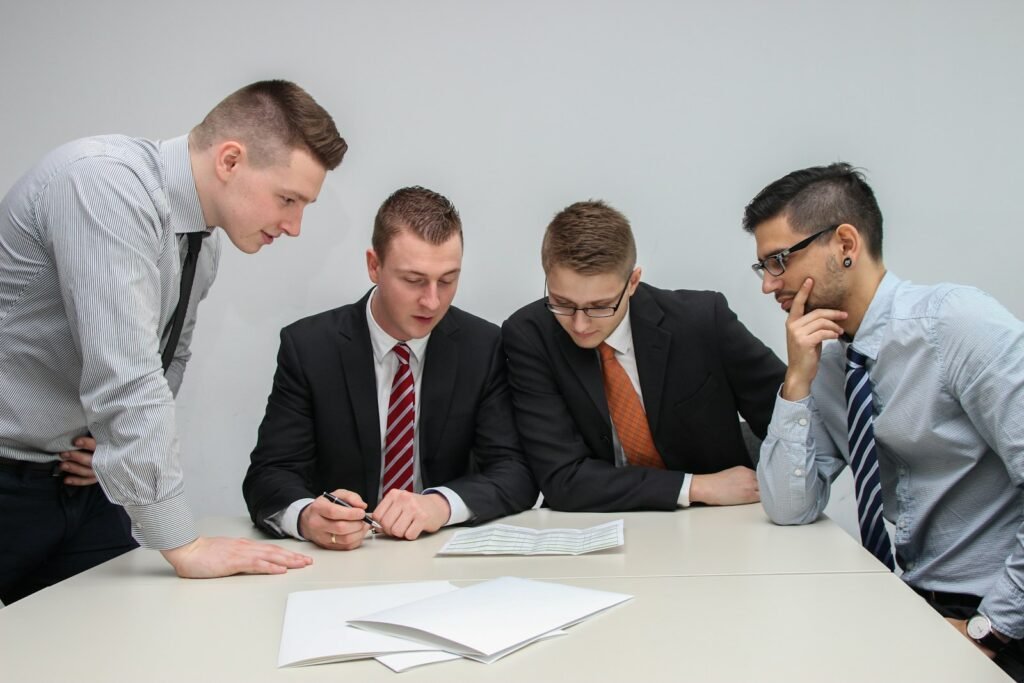 Business team reviewing procurement documents and comparing outsourcing vendor proposals