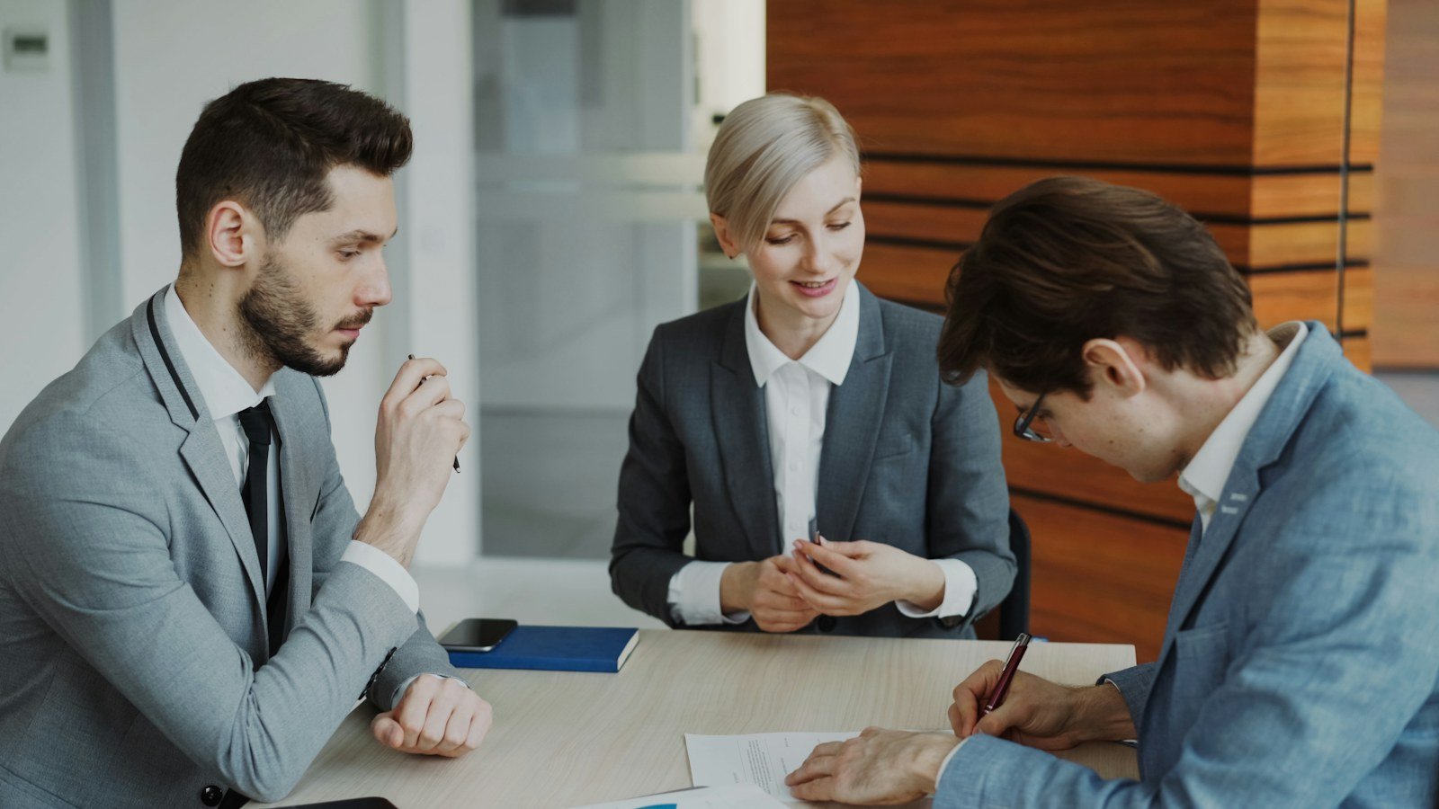 Business professionals reviewing and discussing a service contract before vendor selection