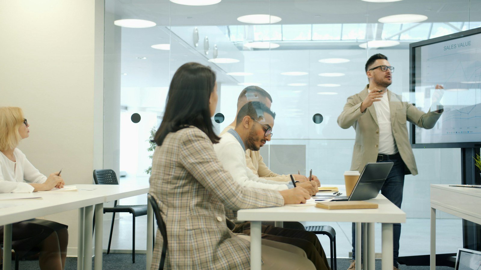 Business team reviewing customer support processes during outsourcing transition training