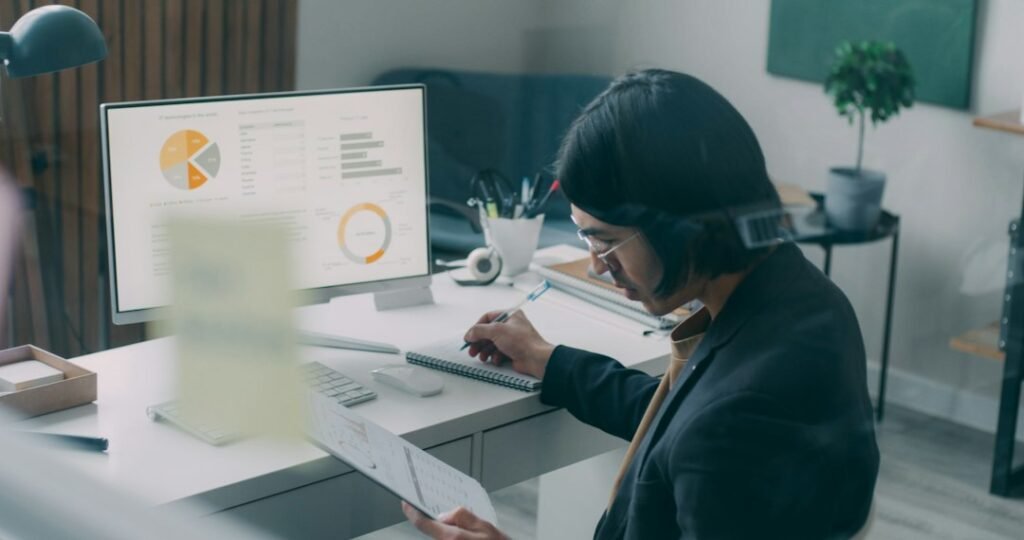 Financial operations professional reviewing loan application documents on a computer